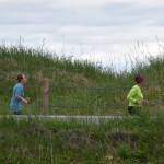 Rachel Boehmler leads another runner along a Kenai beach access road during the Kenai Summer Solstice Fun Run in Kenai, Alaska, on Saturday, June 21, 2025. (Photo by Jeff Helminiak/Peninsula Clarion)