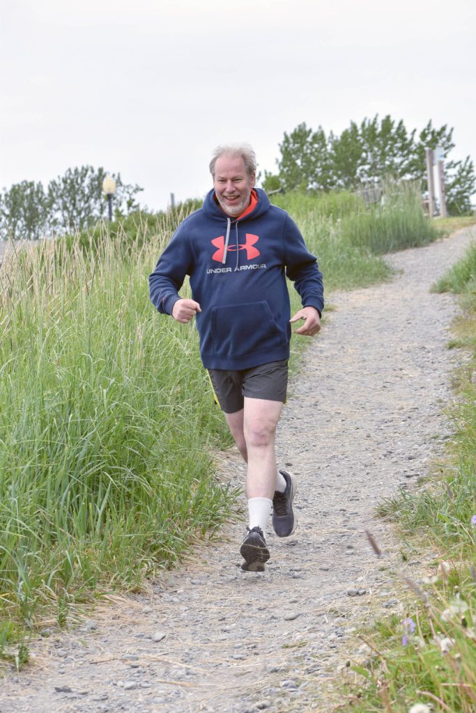 Carl Kincaid of Sterling runs down a path toward the Kenai beach during the Kenai Summer Solstice Fun Run in Kenai, Alaska, on Saturday, June 21, 2025. (Photo by Jeff Helminiak/Peninsula Clarion)