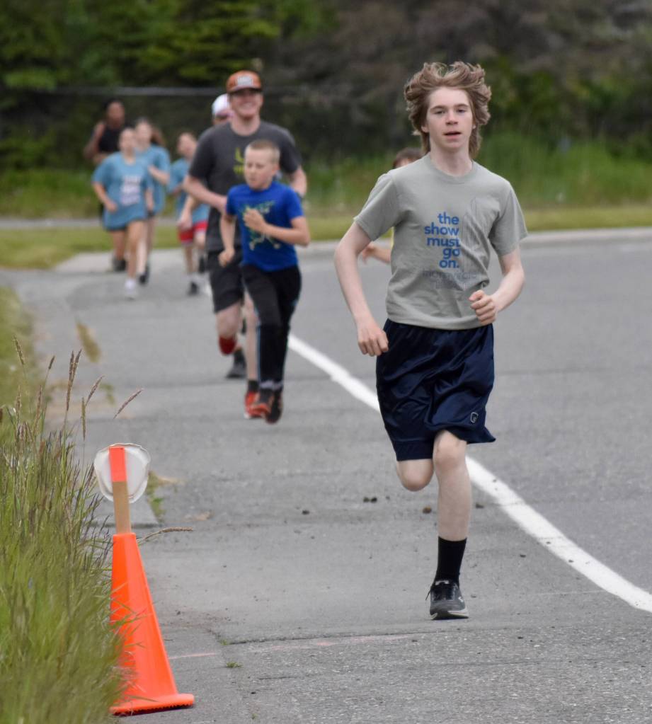 Andrew Warfle of Kenai leads the 5-kilometer pack during the Kenai Summer Solstice Fun Run in Kenai, Alaska, on Saturday, June 21, 2025. (Photo by Jeff Helminiak/Peninsula Clarion)