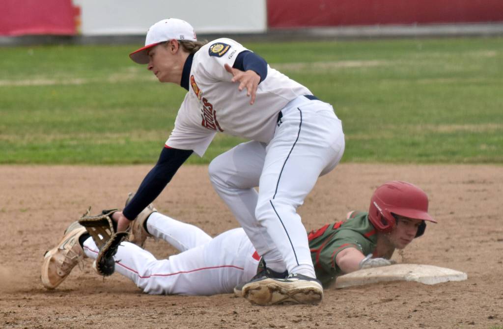 Hayden Hudson of Madisonville (Kentucky) Post 6 gets back to first safely in front of Matthew Schilling of the Post 20 Twins in the championship game of the Lance Coz Wood Bat Tournament on Sunday, June 22, 2025, at Coral Seymour Memorial Park in Kenai, Alaska. (Photo by Jeff Helminiak/Peninsula Clarion)