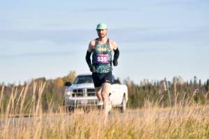 Kenai's Jason Parks runs to a win in the men's marathon at the Kenai River Marathon on Sunday, Sept. 29, 2024, in Kenai, Alaska. (Photo by Jeff Helminiak/Peninsula Clarion)