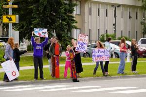 Swimmers and parents protest the proposed closure of Kenai Peninsula Borough School District pools outside of the Kenai Peninsula Borough Administration Building in Soldotna, Alaska, on Thursday, June 26, 2025. (Jake Dye/Peninsula Clarion)