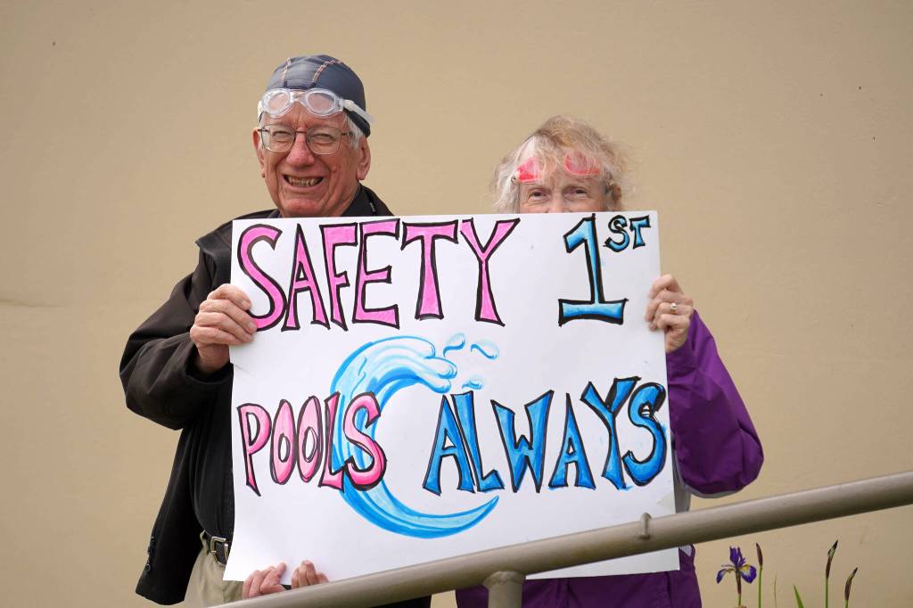 Swimmers and parents protest the proposed closure of Kenai Peninsula Borough School District pools outside of the Kenai Peninsula Borough Administration Building in Soldotna, Alaska, on Thursday, June 26, 2025. (Jake Dye/Peninsula Clarion)