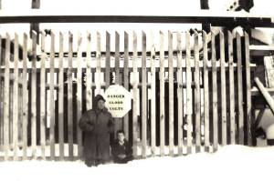 Frank Rowley and his youngest child, Raymond, stand in knee-deep snow in front of the protective fence around the main substation for Mountain View Light & Power in Anchorage in 1948 or 49. This photo was taken a year or two before Rowley moved to Kenai to begin supplying electrical power to the central peninsula. (Photo courtesy of the Rowley Family)