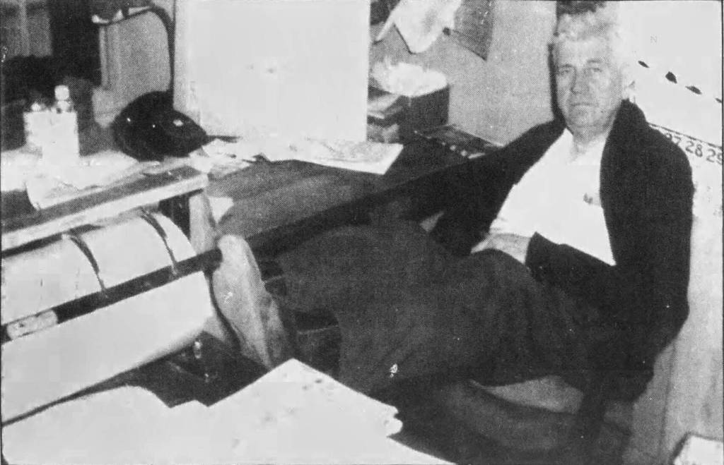 File photo from the Anchorage Times
Slim Eagleston, a junkyard owner who assaulted Frank Rowley and fractured his skull in 1946, is seen here with his feet propped up on the desk in his office just before his 1961 retirement.