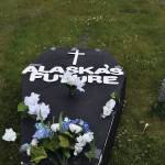 A makeshift coffin decrying potential Medicaid cuts is seen on Thursday, June 26 , in front of the Blazy Mall in Soldotna . The cuts, included in a budget reconciliation bill, passed the U.S. Senate early Tuesday morning. (Photo by Jonas Oyoumick/Peninsula Clarion)