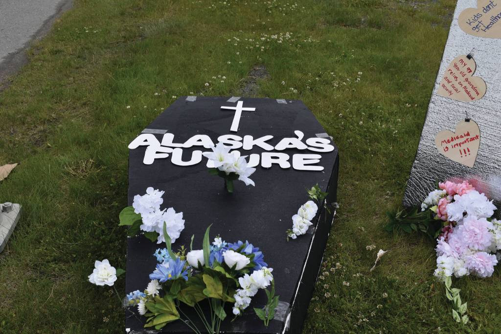 A makeshift coffin decrying potential Medicaid cuts is seen on Thursday, June 26 , in front of the Blazy Mall in Soldotna . The cuts, included in a budget reconciliation bill, passed the U.S. Senate early Tuesday morning. (Photo by Jonas Oyoumick/Peninsula Clarion)
