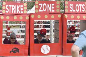 Sharon Tyone, Dan Aaronson and Jessica Small make the "real life slot machine" work at the Oilers All-Star Family Field Day on Saturday, July 5, 2025, at Coral Seymour Memorial Park in Kenai, Alaska. (Photo by Jeff Helminiak/Peninsula Clarion)