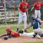Matthew Schilling of the American Legion Post 20 Twins slides safely past Eagle River catcher Jack Mullen on Monday, July 7, 2025, at Coral Seymour Memorial Park in Kenai, Alaska. (Photo by Jeff Helminiak/Peninsula Clarion)