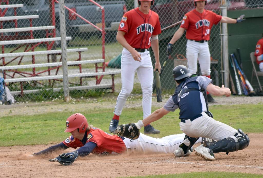 Matthew Schilling of the American Legion Post 20 Twins slides safely past Eagle River catcher Jack Mullen on Monday, July 7, 2025, at Coral Seymour Memorial Park in Kenai, Alaska. (Photo by Jeff Helminiak/Peninsula Clarion)
