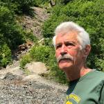 Seward's Fred Moore stands at the base of Mount Marathon in Seward, Alaska, on Monday, June 24, 2019. Moore will run in his 50th consecutive Mount Marathon race on July 4. (Photo by Joey Klecka/Peninsula Clarion)