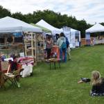 Kids play with a bubble machine set up by one of the vendors at the Concert on the Lawn on Saturday, July 12, 2025, at Karen Hornaday Park in Homer, Alaska. (Delcenia Cosman/Homer News)