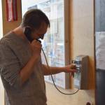 Homer Public Library Director Dave Berry makes an outgoing call on the librarys public phone on Monday, July 7, 2025, in Homer, Alaska. (Delcenia Cosman/Homer News)