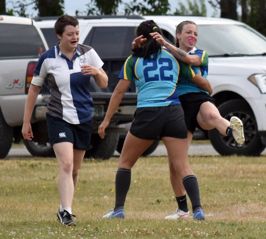 Bri Gentry celebrates scoring a try with Bambi Zhung (22) while Jules Carroll looks on at the Kenai Dipnet Fest Rugby 10s Tournament at Kenais Millennium Square on Saturday, July 19, 2025. (Photo by Jeff Helminiak/Peninsula Clarion)
