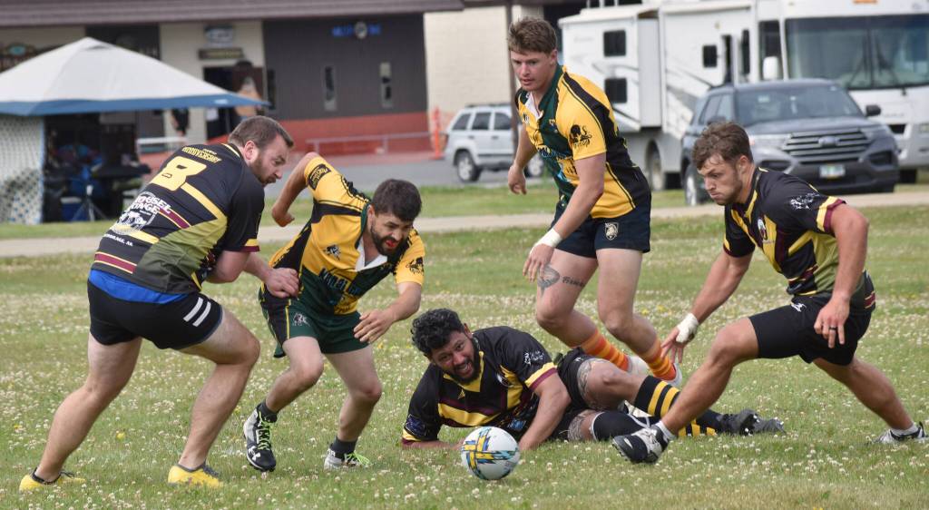 From left to right, Zach Allyn, Victor Rodriguez, Ronald Chand, Ben Richards and Connor OFarrell converge on a loose ball at the Kenai Dipnet Fest Rugby 10s Tournament at Kenais Millennium Square on Saturday, July 19, 2025. (Photo by Jeff Helminiak/Peninsula Clarion)