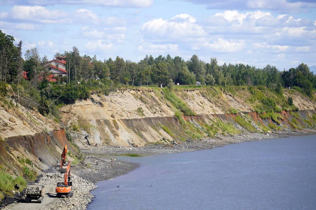 Armor rock from Sand Point is offloaded from a barge in the Kenai River in Kenai, Alaska, part of ongoing construction efforts for the Kenai River Bluff Stabilization Project on Wednesday, July 23, 2025. (Jake Dye/Peninsula Clarion)