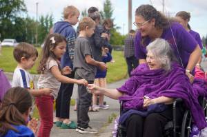 Children take candy from a resident of Heritage Place during the 68th Annual Soldotna Progress Days Parade in Soldotna, Alaska, on Saturday, July 26, 2025. (Jake Dye/Peninsula Clarion)