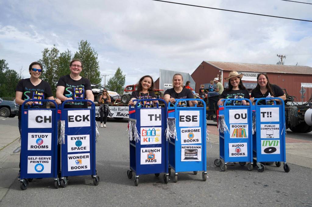 Staff from the Soldotna Public Library push book carts during the 68th Annual Soldotna Progress Days Parade in Soldotna, Alaska, on Saturday, July 26, 2025. (Jake Dye/Peninsula Clarion)