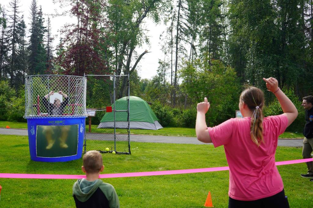 Kenai Peninsula Borough Assembly Member Tyson Cox plunges into the dunk tank during Dunk a Dignitary at the Progress Days Block Party at Parker Park in Soldotna, Alaska, on Saturday, July 26, 2025. (Jake Dye/Peninsula Clarion)