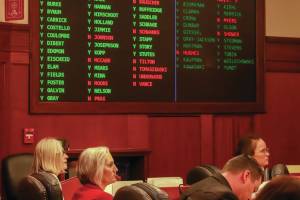 Rep. Andi Story (D-Juneau), Rep. Rebecca Himschoot (I-Sitka), and Rep. Sarah Vance (R-Homer) watch the vote tally during a veto override joint session on an education bill Tuesday, May 20. (Jasz Garrett / Juneau Empire)