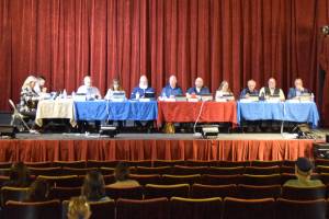 The Kenai Peninsula Borough Assembly gathers before the beginning fo the Aug. 5, 2025, KPB Assembly meeting at the Porcupine Theater in Homer, Alaska. (Chloe Pleznac/Homer News)