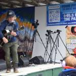 Tim Easton interacts with a young Salmonfest-goer during his set at the Inlet Stage on Saturday, Aug. 2, 2025, at the Kenai Peninsula Fairgrounds in Ninilchik, Alaska. (Delcenia Cosman/Homer News)
