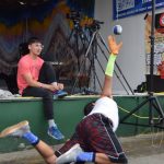 Trevor Edwards performs the one hand reach during a Native Youth Olympics demonstration at the Inlet Stage on Saturday, Aug. 2, 2025, at the Kenai Peninsula Fairgrounds in Ninilchik, Alaska. (Delcenia Cosman/Homer News)