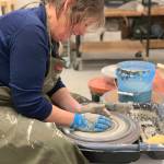 A community member works with clay on a wheel in the ceramics studio at Homer Council on the Arts in Homer, Alaska. (Photo provided by Homer Council on the Arts)