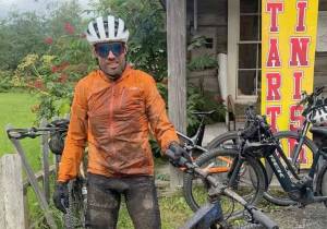 Seward's Chaz DiMarzio dismounts his bike after winning the Soggy Bottom 100 on Saturday, Aug. 2, 2025, in Hope, Alaska. (Photo provided)