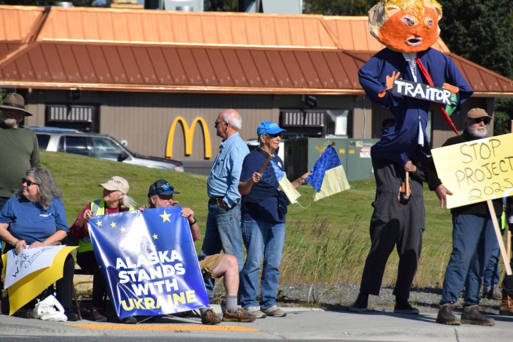 A protester carries an effigy of President Donald Trump at the intersection of Lake Street and the Sterling Highway in Homer, Alaska, following President Donald Trumps meeting in Anchorage with Russian President Vladimir Putin on Friday, Aug. 15, 2025. (Delcenia Cosman/Homer News)