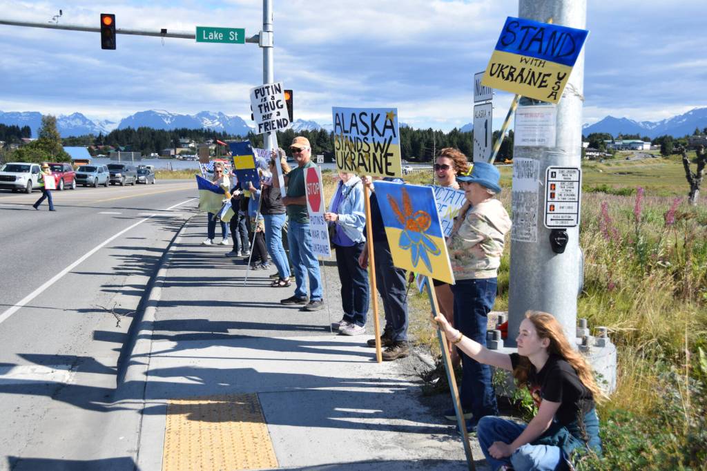 Protesters hold up signs expressing support for Ukraine on Friday, Aug. 15, 2025, in Homer, Alaska. (Delcenia Cosman/Homer News)