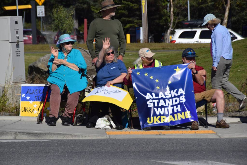 Protesters hold up signs expressing support for Ukraine on Friday, Aug. 15, 2025, at the intersection of Lake Street and the Sterling Highway in Homer, Alaska. (Delcenia Cosman/Homer News)