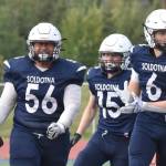 Soldotna's Koda Lepule celebrates a fumble recovery with Matthew Innes and Liam Peck on Friday, Aug. 15, 2025, at Justin Maile Field at Soldotna High School in Soldotna, Alaska. (Photo by Jeff Helminiak/Peninsula Clarion)