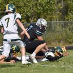 Sewards Ridge Conant and Cai Turner and Nikiskis Mason Doth scramble for a fumble Saturday, Aug. 16, 2025, at Nikiski Middle-High School in Nikiski, Alaska. Conant would pick up the ball and score. (Photo by Jeff Helminiak/Peninsula Clarion)