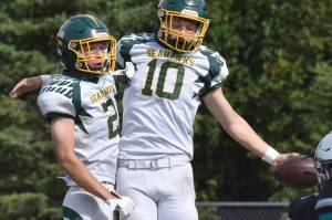 Seward's Lane Petersen and Emerson Cross celebrate a touchdown Saturday, Aug. 16, 2025, at Nikiski Middle-High School in Nikiski, Alaska. (Photo by Jeff Helminiak/Peninsula Clarion)