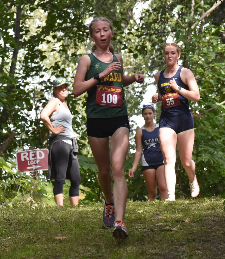 Sewards Juniper Ingalls leads Homers Claira Booz in the junior-senior girls race at the Kenai/Nikiski Class Races on Monday, Aug. 18, 2025, at Nikiski Middle-High School in Nikiski, Alaska. (Photo by Jeff Helminiak/Peninsula Clarion)