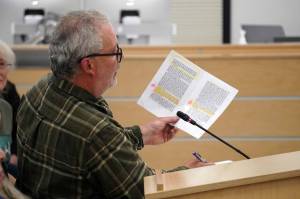 David Haeg reads from an annotated copy of a grand jurists handbook during a town hall on the Alaska grand jury process in the Betty J. Glick Assembly Chambers in Soldotna, Alaska, on Monday, Aug. 18, 2025. (Jake Dye/Peninsula Clarion)