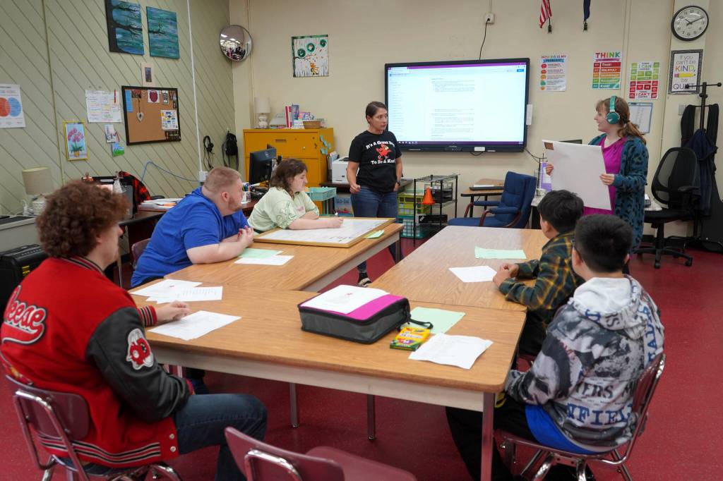Sami McKeon-Brantley discusses a daily calendar with students on the first day of the 2025-2026 school year at Kenai Central High School on Wednesday. (Jake Dye/Peninsula Clarion)