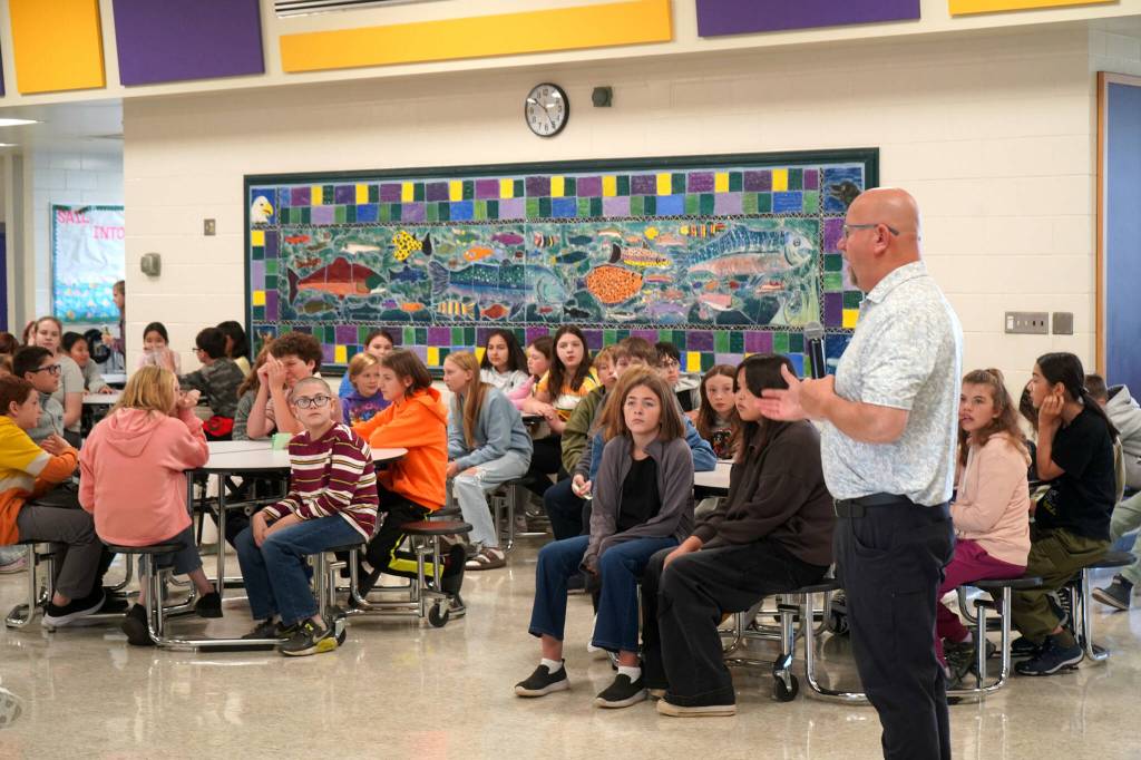 Vaughn Dosko speaks to a crowd of new sixth graders during the first day of the 2025-2026 school year at Kenai Middle School on Wednesday. (Jake Dye/Peninsula Clarion)