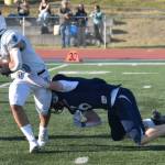 Chugiaks Nico Santiago is tackled by Soldotnas Liam Peck on Friday, Aug. 22, 2025, at Justin Maile Field at Soldotna High School in Soldotna, Alaska. (Photo by Jeff Helminiak/Peninsula Clarion)