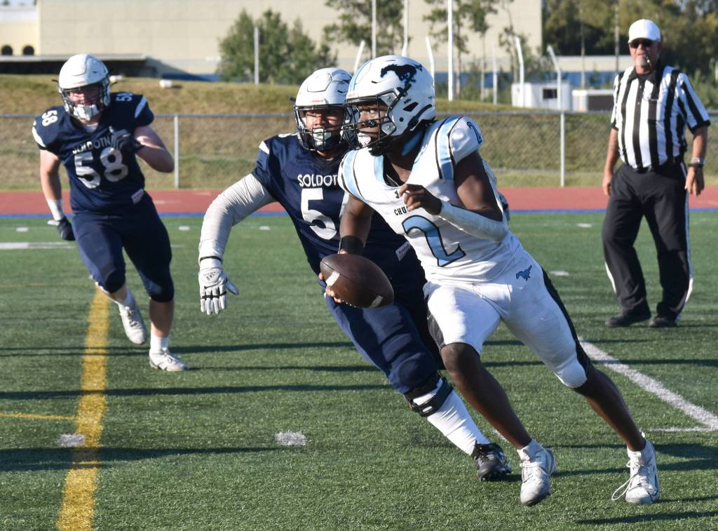 Soldotnas Theo Huff and Koda Lepule chase Chugiak quarterback Ahmir Walker on Friday, Aug. 22, 2025, at Justin Maile Field at Soldotna High School in Soldotna, Alaska. (Photo by Jeff Helminiak/Peninsula Clarion)