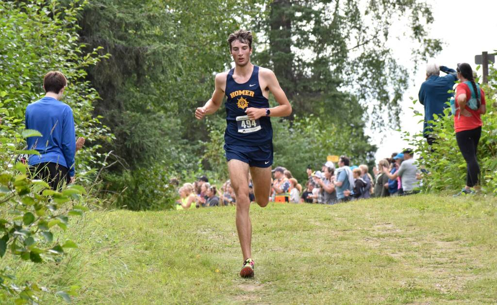 Homers Johannes Bynagle runs to third place in the boys varsity race at the Ted McKenney XC Invitational on Saturday, Aug. 23, 2025, at Tsalteshi Trails just outside of Soldotna, Alaska. (Photo by Jeff Helminiak/Peninsula Clarion)