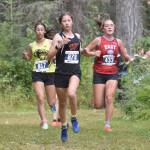 Wasillas Hailee Giacobbe leads Souths Calista Zuber and Easts Rosie Conway in the girls varsity race at the Ted McKenney XC Invitational on Saturday, Aug. 23, 2025, at Tsalteshi Trails just outside of Soldotna, Alaska. Giacobbe was first, while Conway was second and Zuber was third. (Photo by Jeff Helminiak/Peninsula Clarion)