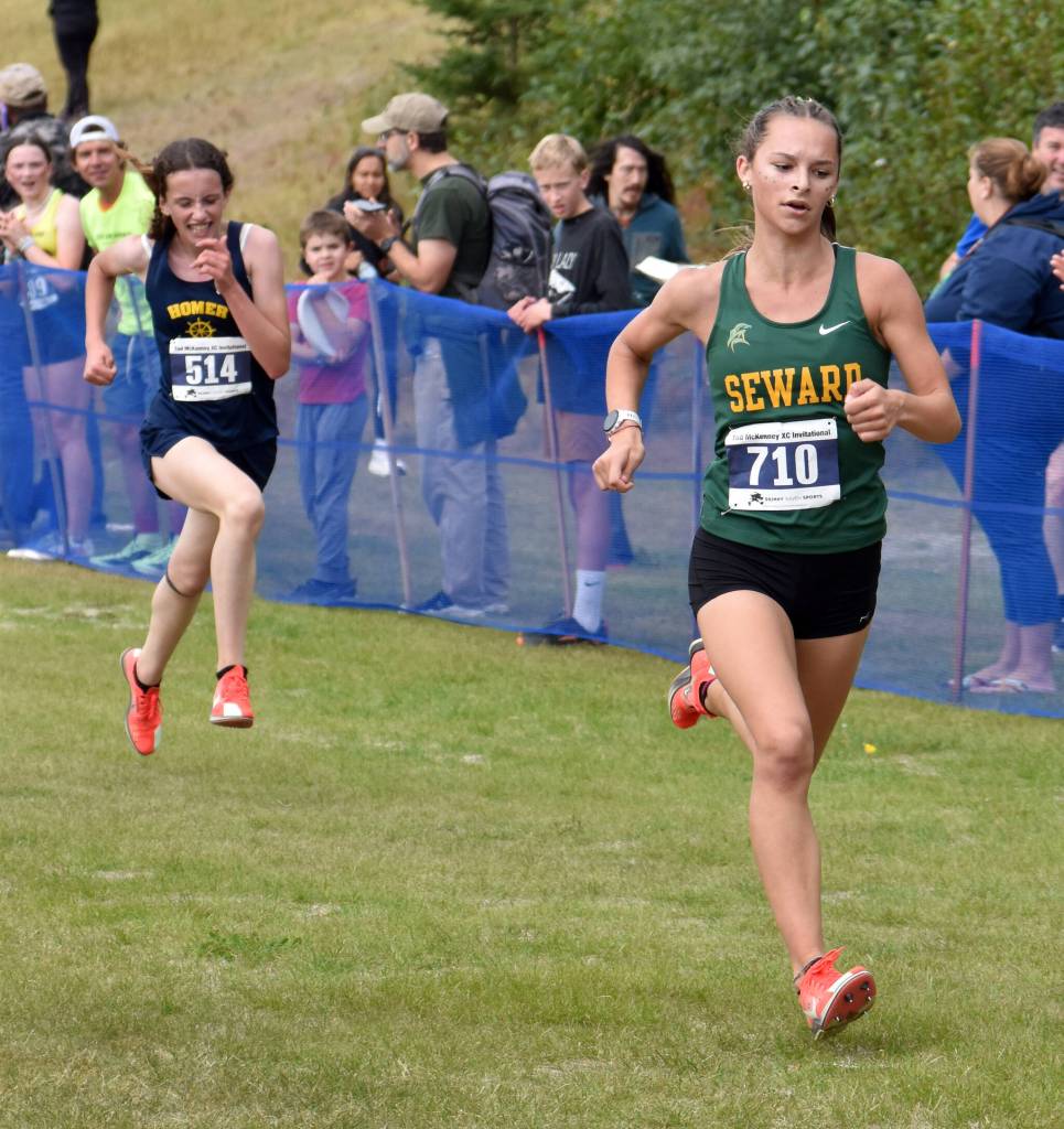 Sewards Olive Jordan holds off Homers Ariela Garvey at the finish of the girls varsity race at the Ted McKenney XC Invitational on Saturday, Aug. 23, 2025, at Tsalteshi Trails just outside of Soldotna, Alaska. (Photo by Jeff Helminiak/Peninsula Clarion)
