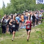 Souths Vebjorn Flagstad and Easts Katahdin Staples share the lead early in the boys varsity race at the Ted McKenney XC Invitational on Saturday, Aug. 23, 2025, at Tsalteshi Trails just outside of Soldotna, Alaska. Staples won, while Flagstad was second. (Photo by Jeff Helminiak/Peninsula Clarion)