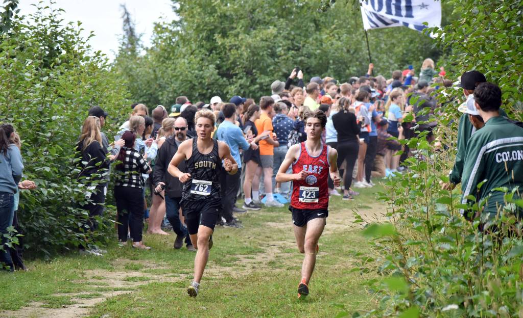 Souths Vebjorn Flagstad and Easts Katahdin Staples share the lead early in the boys varsity race at the Ted McKenney XC Invitational on Saturday, Aug. 23, 2025, at Tsalteshi Trails just outside of Soldotna, Alaska. Staples won, while Flagstad was second. (Photo by Jeff Helminiak/Peninsula Clarion)