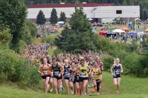 Service's Talia Smith leads the girls varsity pack near the start of the Ted McKenney XC Invitational on Saturday, Aug. 23, 2025, at Tsalteshi Trails just outside of Soldotna, Alaska. (Photo by Jeff Helminiak/Peninsula Clarion)