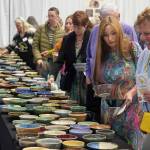 Attendees of the Kenai Peninsula Food Banks annual Soup Supper fundraiser browse ceramic bowls, made by the Kenai Potters Guild, at the Soldotna Field House in Soldotna, Alaska, on Saturday, Aug. 23, 2025. (Jake Dye/Peninsula Clarion)