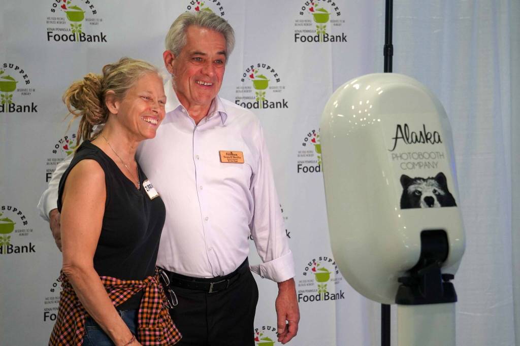 Kenai Peninsula Food Bank Board President Sean OReilly, right, takes a photo with Zirrus VanDevere at the Kenai Peninsula Food Banks annual Soup Supper fundraiser at the Soldotna Field House in Soldotna, Alaska, on Saturday, Aug. 23, 2025. (Jake Dye/Peninsula Clarion)