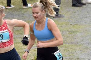 Nevada's Claire Nelson, 22, and Anchorage's Taylor Deal, 31, approach the mountain during the women's race at the Mount Marathon Race on July 4, 2025, in Seward, Alaska. (Photo by Jeff Helminiak/Peninsula Clarion)